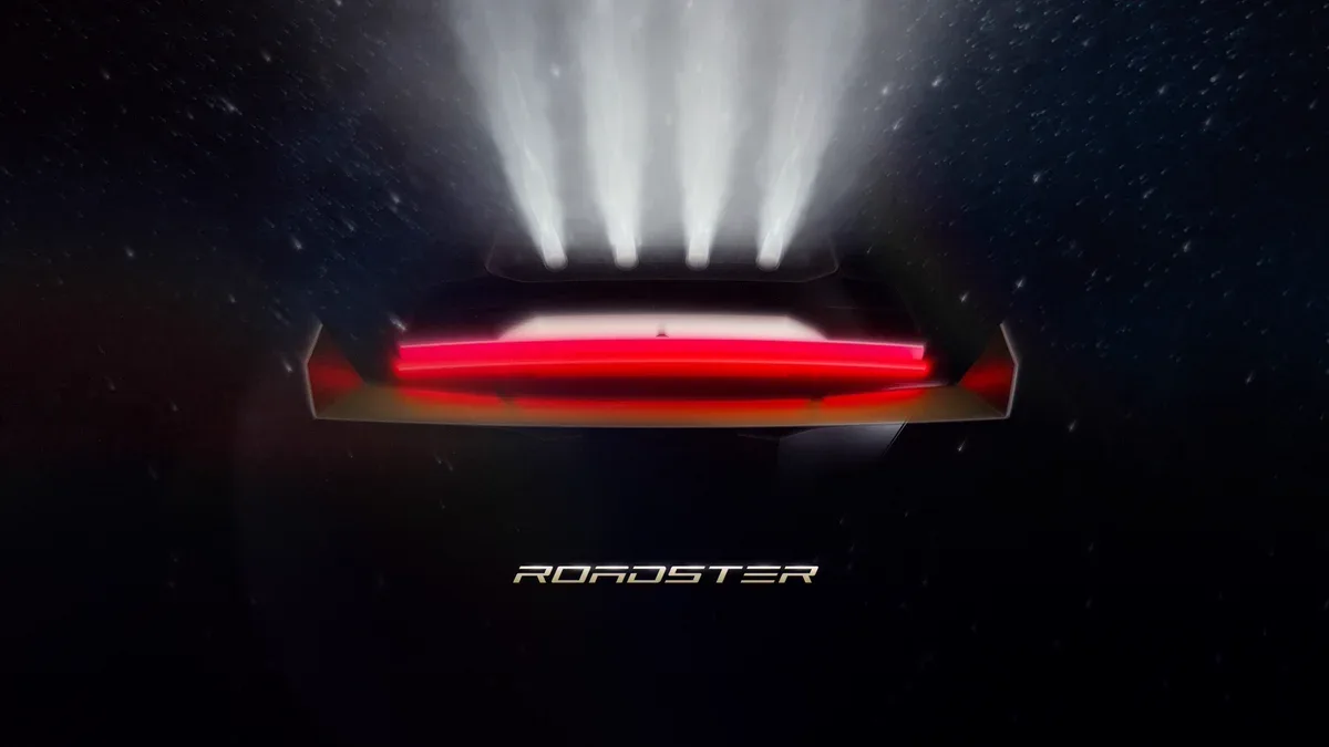 Official Roadster broadcast artwork with a red rear light bar and four bright plumes above the car.